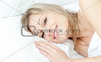 Smiling woman relaxing in a bed