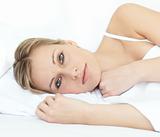 Charming woman relaxing in a bed 