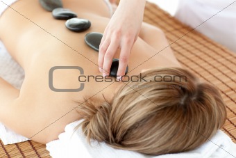Relaxed woman having a stone therapy