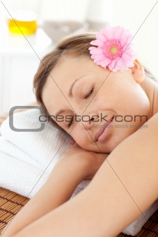Portrait of  a delighted woman relaxing on a massage table