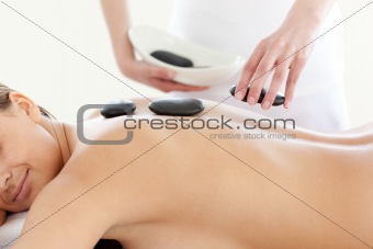 Portrait of a cute woman having a massage with stones