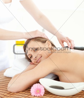 Portrait of a confident woman having a massage with stones