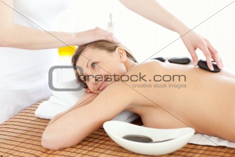 Portrait of a joyful woman having a massage with stones 