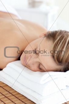Portrait of a teen woman having a massage with stones