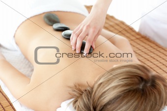 Bright woman having a stone therapy