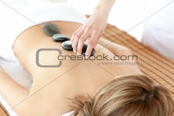 Radiant woman having a stone therapy