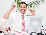 Cheerful businessman punching the air in celebration