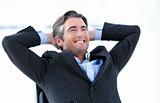Laughing male executive thinking about his success