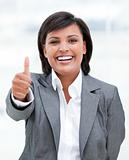 Portrait of a fortunate business woman with a thumb up