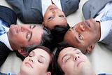 Close-up of relaxed business team lying in circle