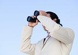 Portrait of an handsome business man looking through binoculars