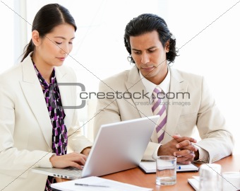 Concentrated business people working at a laptop 
