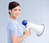 Smiling businesswoman holding a megaphone