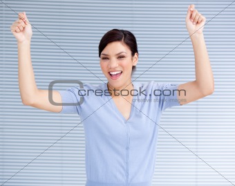 Successful businesswoman punching the air in celebration