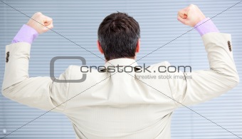 Businessman puniching the air in celebration