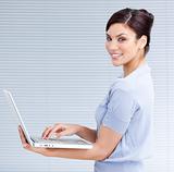 Cheerful businesswoman using a laptop