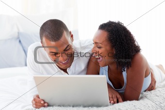 Happy couple using a laptop 