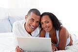Romantice couple using a laptop 