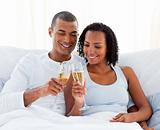 Cheerful couple toasting with Champagne