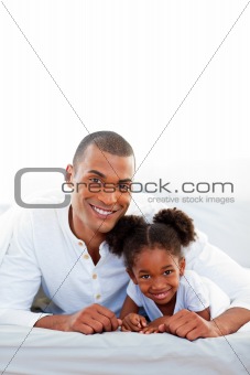 Attentive father and his daughter smiling at the camera