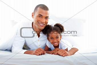 Caring father and his daughter smiling at the camera