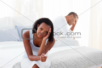 Disconcerted couple finding out results of a pregnancy test 