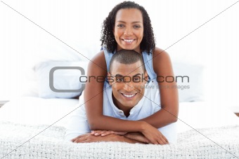 Portrait of  an intimate couple cuddling lying down on bed