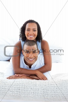 Portrait of a romantic couple cuddling lying down on bed