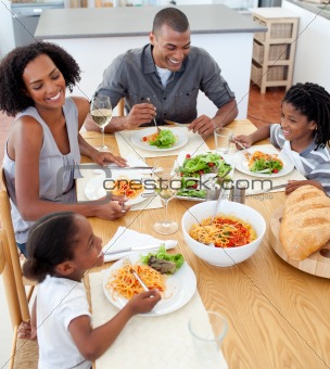 Smiling family dining together