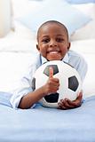 Adorable little boy holding a soccer ball 