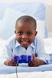 Cute little boy playing video game