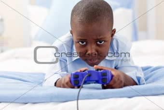 Happy little boy playing video game