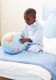 Little boy holding a terrestrial globe