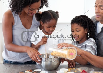 Ethnic family making biscuits together