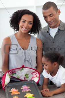 Smiling family showing handmade cookies
