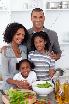 Ethnic family preparing salad together