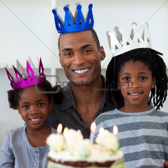 Smiling father with his children celebrating a birthday 