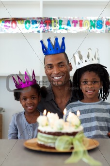 Joyful Afro-american father with his children celebrating a birt