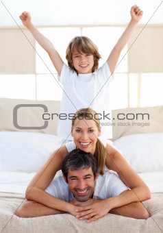 Happy boy playing with his parents