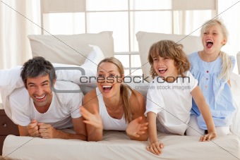 Laughing parents playing with their children