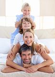 Happy family having fun on a bed