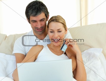 Jolly couple buying on internet