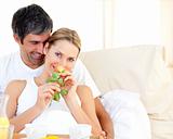 Close-up of couple having breakfast lying in the bed