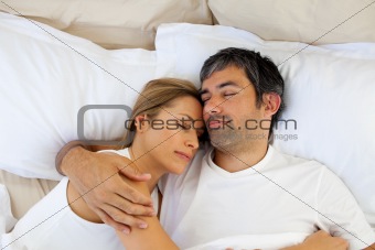 Caring lovers sleeping lying in the bed