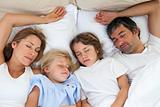 Loving family sleeping together 