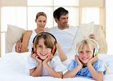 Cute siblings listening music with headphones