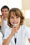 Little boy singing with a microphone