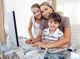 Caring mother and her children at a computer
