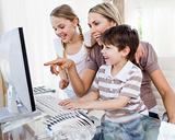 Children and their mother using a computer