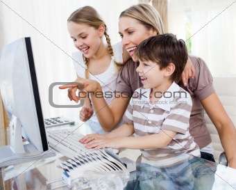 Children and their mother using a computer